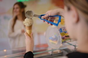 Gelato skopas upp på en våffelstrut vid en glassdisk